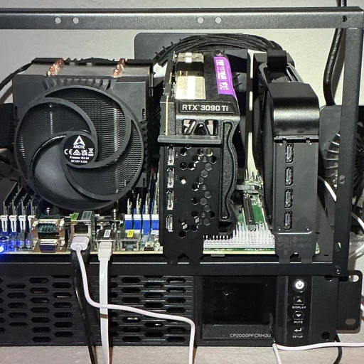 a photograph of the workstation after the swap, taken 2026-09-25: an EVGA GeForce RTX 3090 Ti FTW3 Ultra lit pink beside the bracket of an RTX PRO 6000, a CPU cooler at left and the battery backup below